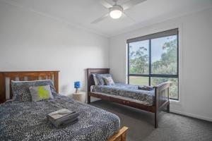 a bedroom with two beds and a window at Long Island Retreat - Rosella in Murray Bridge