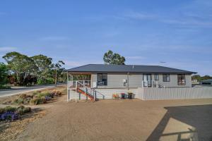 a small white house on the side of a road at Long Island Retreat - Rosella in Murray Bridge