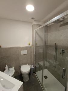 a bathroom with a shower and a toilet and a sink at Su Planu in Cagliari +10 photos