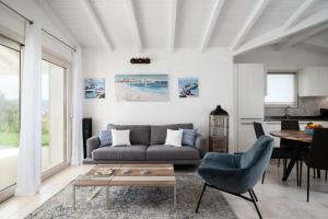 a living room with a couch and a table at Villa Ca' La Luna by Klodge in Budoni