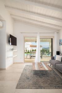 a living room with a couch and a table at Villa Ca' La Luna by Klodge in Budoni