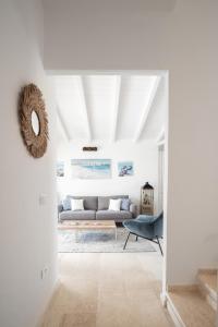 a living room with a couch and a table at Villa Ca' La Luna by Klodge in Budoni +49 photos