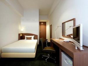 Postel nebo postele na pokoji v ubytování Fuchu Urban Hotel Annex