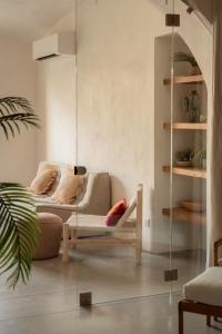 a living room with a couch and a glass wall at Montera appartement centre ville avec piscine chauffée et jardin in Bastia
