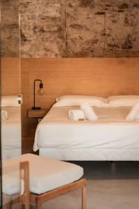 a bedroom with two beds with white sheets at Montera appartement centre ville avec piscine chauffée et jardin in Bastia