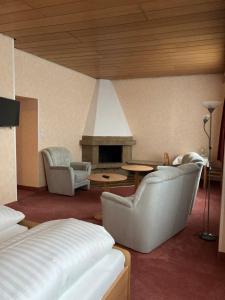 a living room with two chairs and a fireplace at Haus Seeblick in Norderney