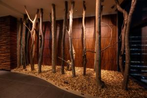 a row of trees in a room with a wall at Hotel Gracery Sapporo in Sapporo