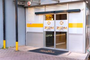 an entrance to a zomon hotel with a sign in the door at zoom hotels in Eskiömerler