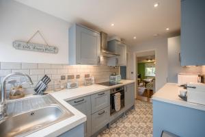 a kitchen with a sink and a counter top at 1 Lavender Cottages, Knodishall in Saxmundham