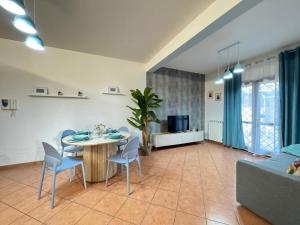 a living room with a table and chairs and a couch at Casa Letizia in Ladispoli