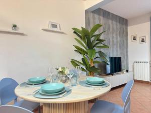 a dining room with a table and a tv at Casa Letizia in Ladispoli