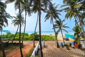 a view of the beach from a resort with palm trees at Open Hotel by Olive - Amani Beach Stay in Māvalli +67 photos