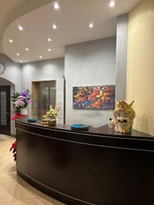 a lobby with a counter with a painting on the wall at Hotel al ritrovo in Castelluzzo
