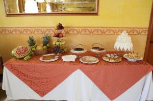 a table with food on top of it at Hotel APAN in Reggio di Calabria +4 photos