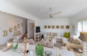 a living room with a couch and a table at The Sullies in Morganʼs Bay