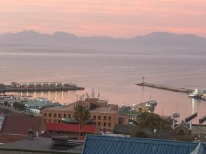 a city with a harbor and a boat in the water at Memento Vivere in Mossel Bay