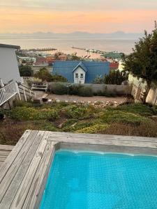 a swimming pool in front of a house at Memento Vivere in Mossel Bay