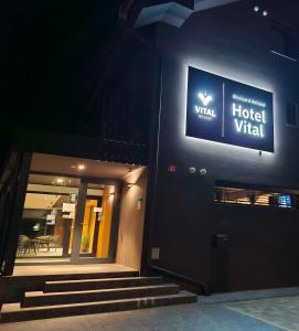 a hotel vital sign on the side of a building at Boutique & Wellness Hotel Vital in Moravske Toplice