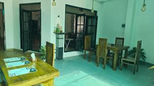 a living room with a wooden table and chairs at Three Elements Mirissa in Mirissa +35 photos