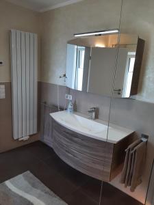 een badkamer met een wastafel en een spiegel bij Ferienwohnung Schabmüller in Kelheim