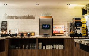 a kitchen with a counter with aasteryasteryasteryasteryasteryasteryasteryasteryastery at De oude gevangenis Almelo in Almelo +14 photos