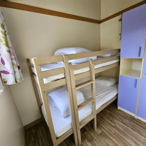 a bunk bed with four bunk beds in a room at Chalet KABANA in Saint-Hilaire-de-Riez +15 photos
