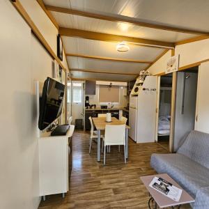 a living room with a couch and a table at Chalet KABANA in Saint-Hilaire-de-Riez
