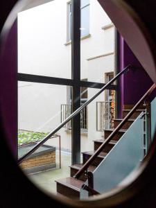 a view from a round window of a stairway at Eurotraveller Hotel - Premier - Tower Bridge in London
