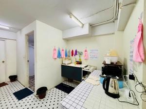 a kitchen with a sink and a counter in a room at BKK Rama3 Guest House in Bangkok