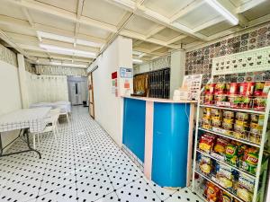 a grocery store aisle with a blue counter in a store at BKK Rama3 Guest House in Bangkok