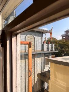 an open window of a balcony with a fence at Sunny Side Up top-floor apartment in Kathmandu
