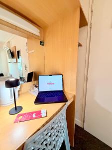 a laptop computer sitting on top of a desk at Fasthotel Orleans Zénith in Orléans +28 photos