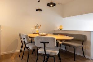 a dining room with a wooden table and chairs at Hello Zeeland - De Brabander Wijk 111 in Cadzand
