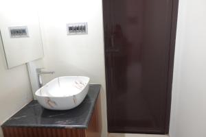 a bathroom with a bowl sink on a counter at Thiruveesar Family Retreat near Airport in Tiruchirappalli