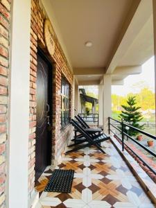 a porch with a black door and a tiled floor at Annapurna View Lodge in Chitwan +30 photos