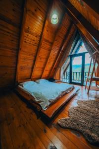 a bedroom with a bed in a wooden house at Sapanca Ruby Bungalow in Sapanca
