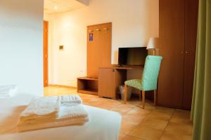 En eller flere senge i et værelse på Hotel Conte Luna