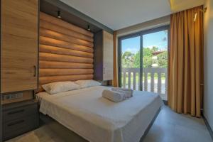 a bedroom with a large bed and a large window at Kalender Pansiyon Fethiye in Fethiye +57 photos