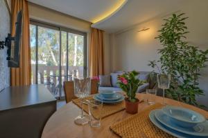a dining room table with plates and glasses on it at Kalender Pansiyon Fethiye in Fethiye