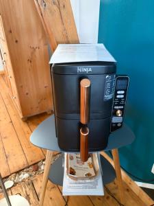 a coffee maker sitting on top of a table at Ferienwohnung Hamburg - Kirchwerder in Hamburg