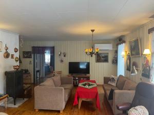 a living room with two couches and a tv at Bestemorhuset in Øye