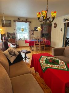 a living room with a couch and a table at Bestemorhuset in Øye