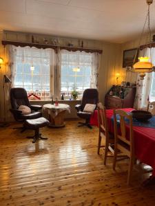 a living room with a table and chairs and a table at Bestemorhuset in Øye +7 photos