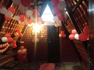 a room with red and white balloons hanging from a ceiling at teak trail in Pune