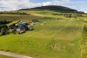 an aerial view of a field with the word home farm written in the grass at Blockhütte am Flugplatz mit Pool in Kühndorf +2 photos