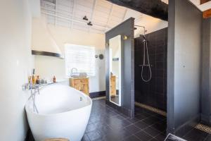 a bathroom with a white tub and a shower at B&B Kasteel Maurick in Vught +36 photos
