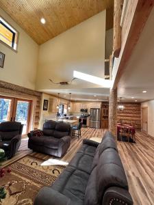 a living room with a couch and a table at Waterfront Log Cabin - Sunriver in Bend