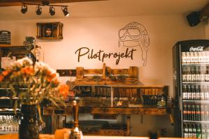 a store with a sign on the wall of a restaurant at Blockhütte am Flugplatz mit Pool in Kühndorf