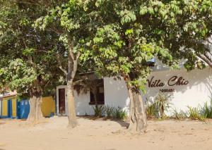 a white building with trees in front of it at casa n 3 jeri in Jericoacoara