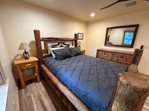 a bedroom with a wooden bed and a mirror at Waterfront Log Cabin - Sunriver in Bend